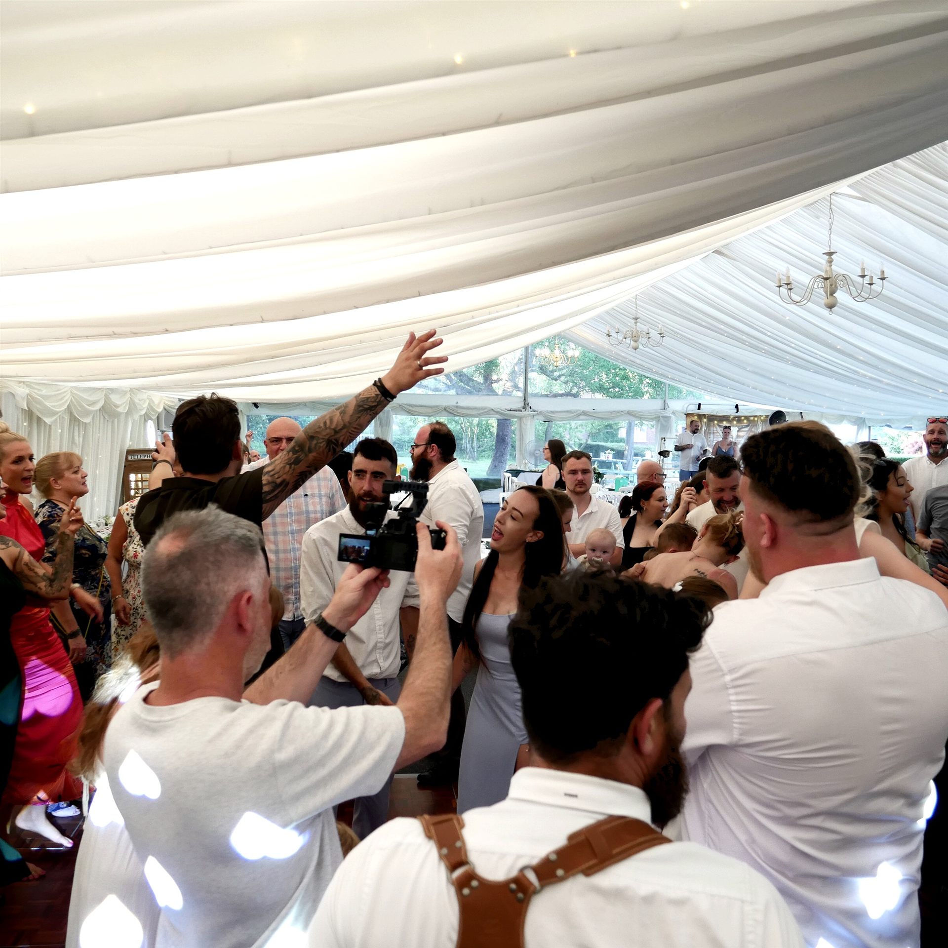 Guests gathered close together enjoying a wedding party