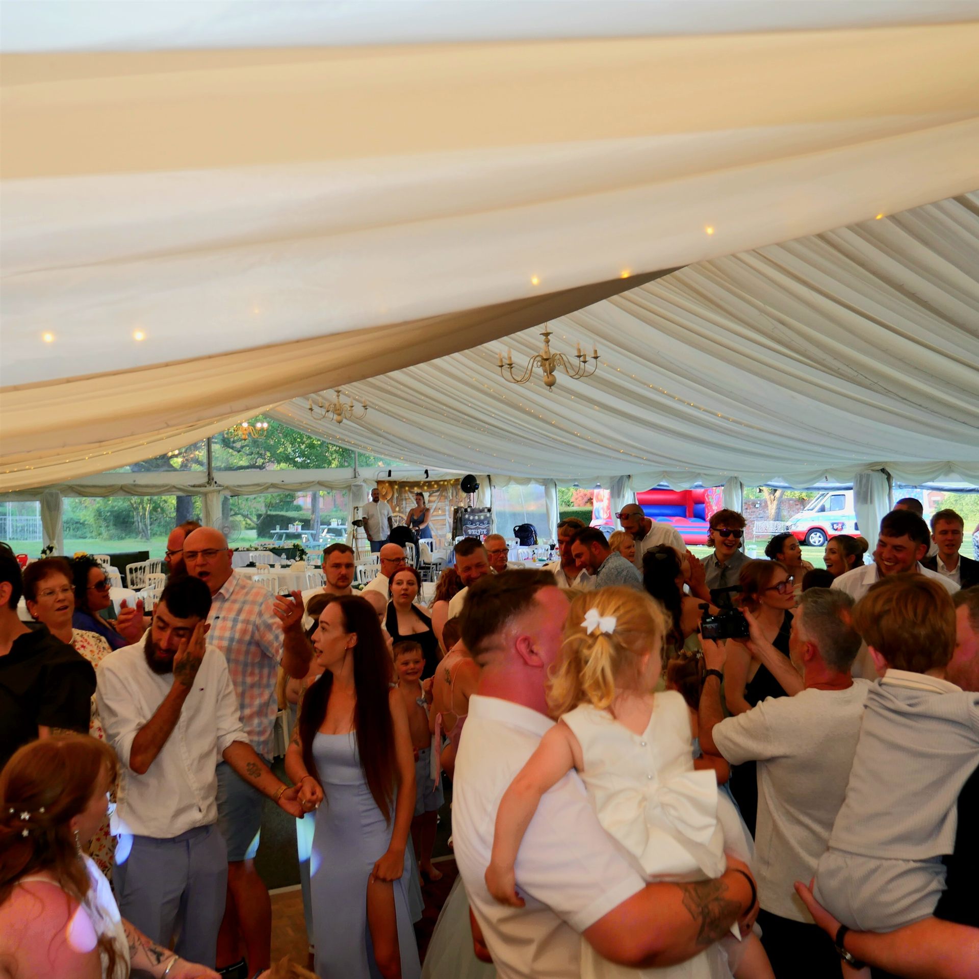Wedding guests enjoying a lively party in a marquee