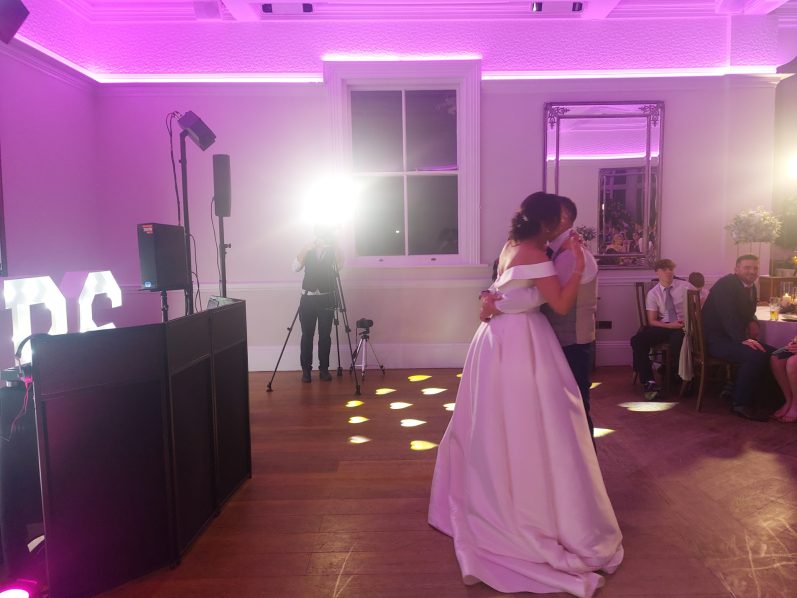 Make your Bride and groom share a first dance in a softly lit venue with pink lights.